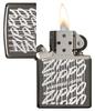 Zippo Script Windproof Lighter with its lid open and lit