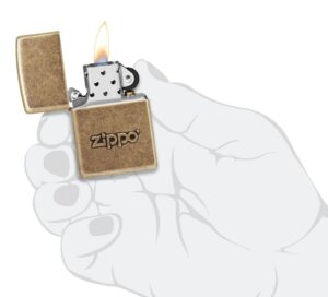 Zippo Stamp Antique Brass Lighter lit in hand.